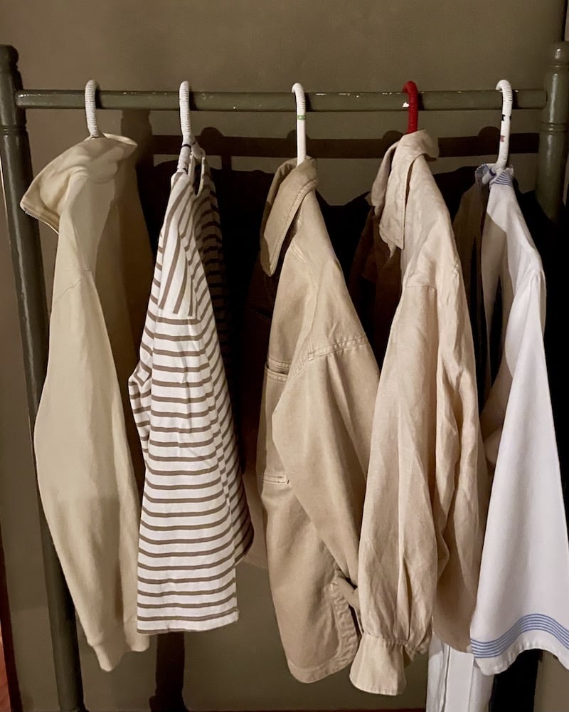 Rack of beige clothes for safari in Kenya