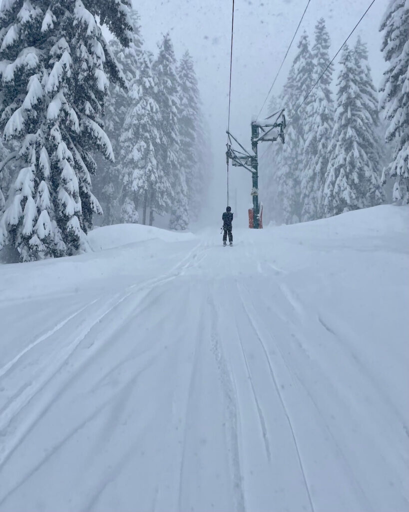 Snowy conditions in Bernex ski resort on drag lift