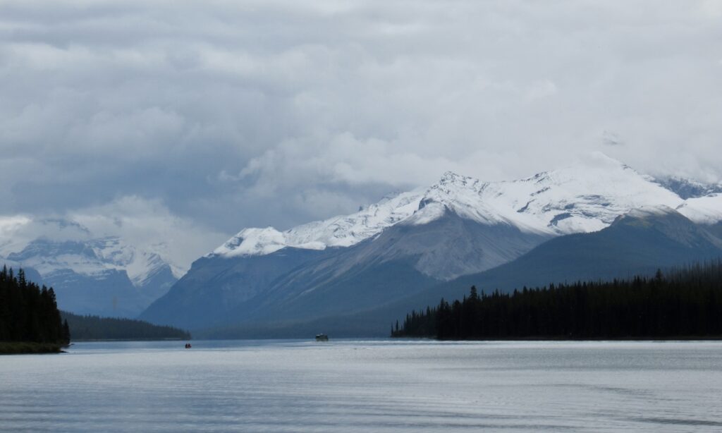 Maligne Lake in Jasper with snowy mountains and clouds