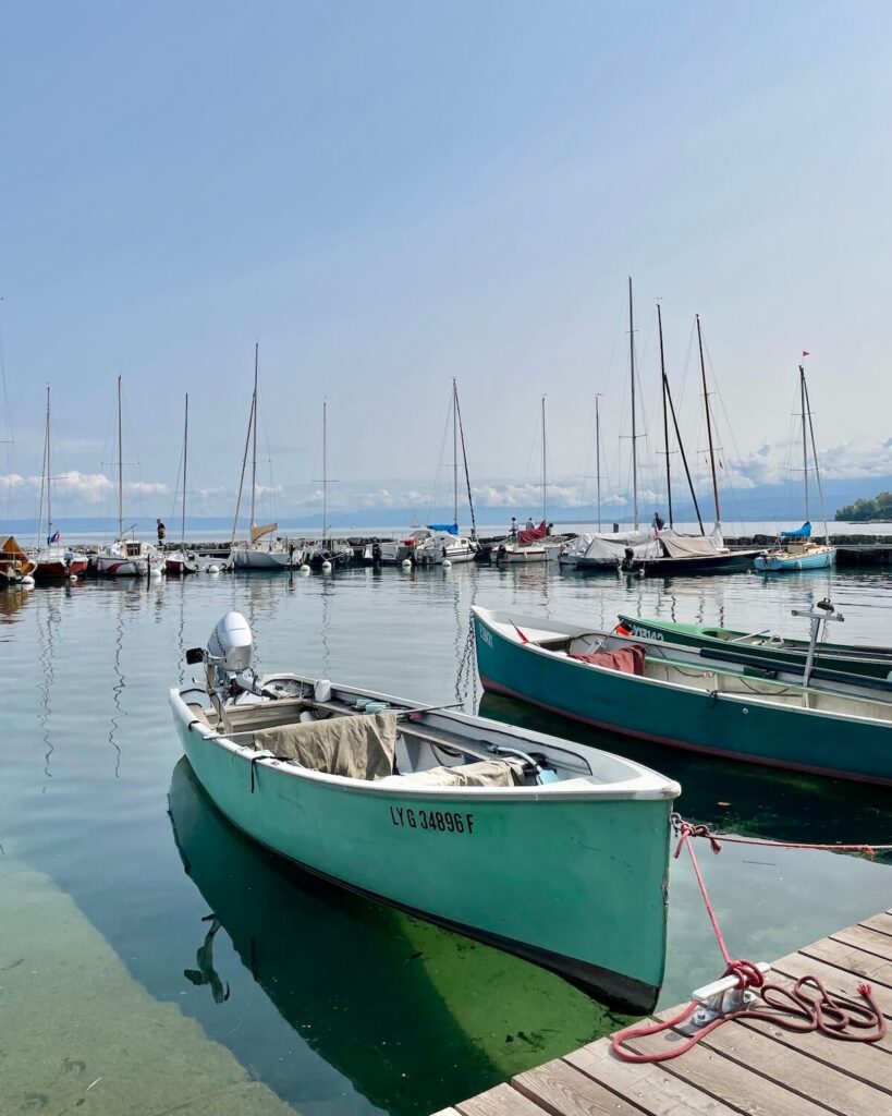 Yvoire port with sail boats and fishing boats on water