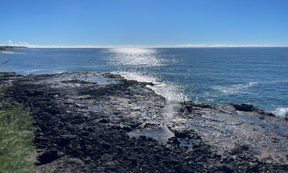 Rocky coastline and blue sky at Spouting Horn park in Poipu Kauai