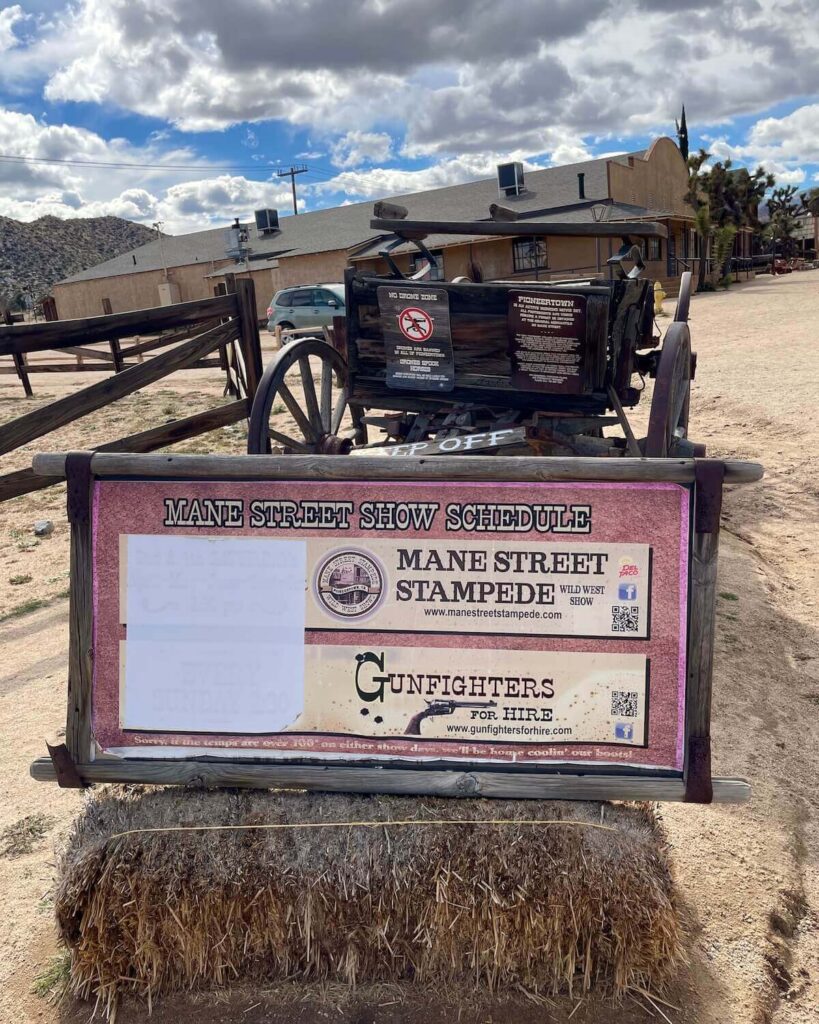 Mane Street Show Schedule board on Hay Bale with tractor
