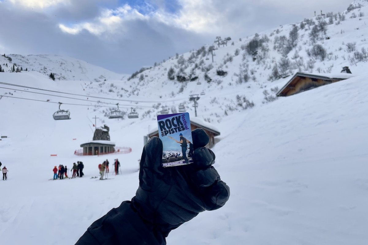 Portes du Soleil ski pass held by gloves with mountain in background