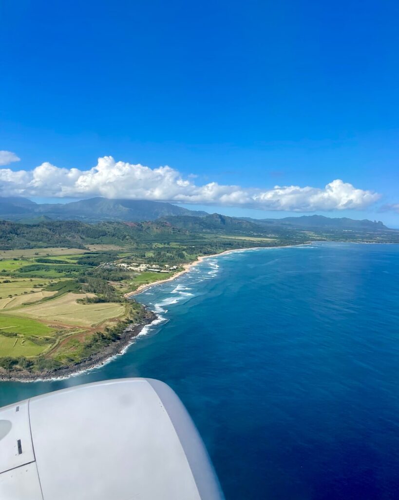 View from airplane of Kauai on sunny day with view of island