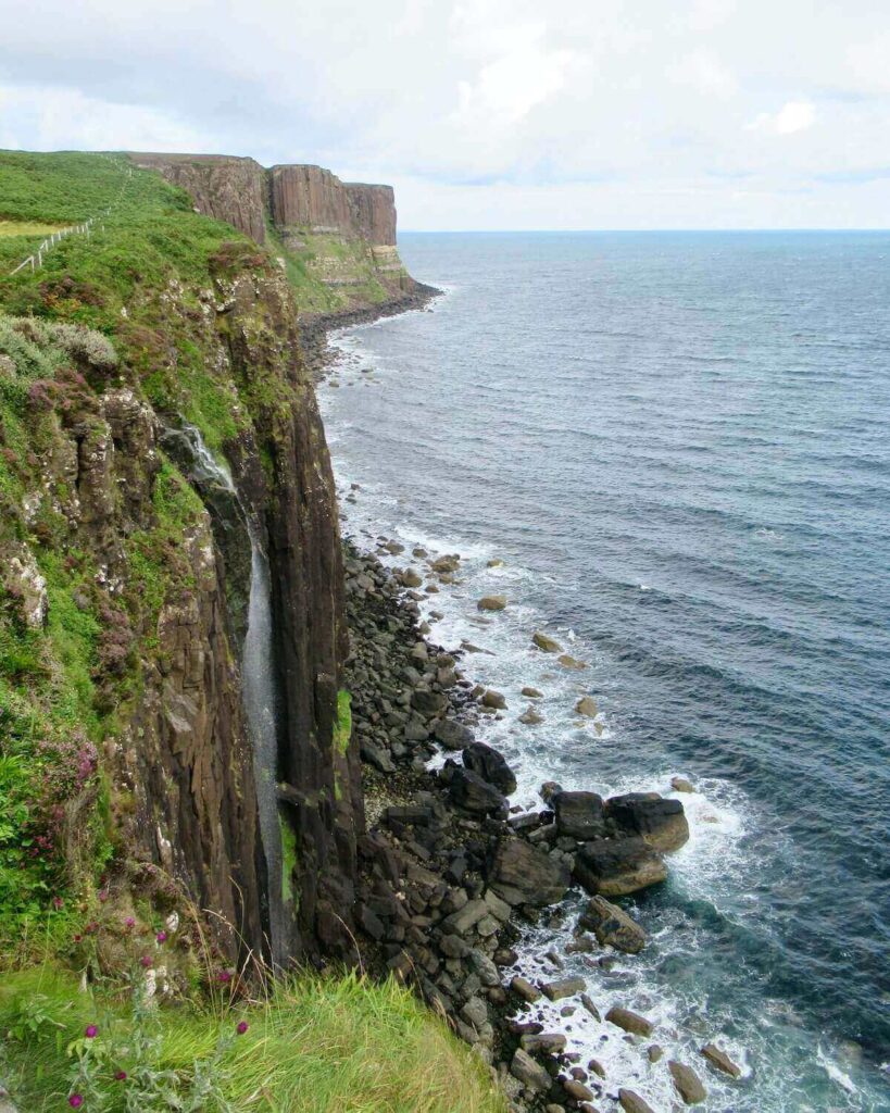 Kilt Rock & Mealt Falls waterfall - view of grassy cliffs and sea
