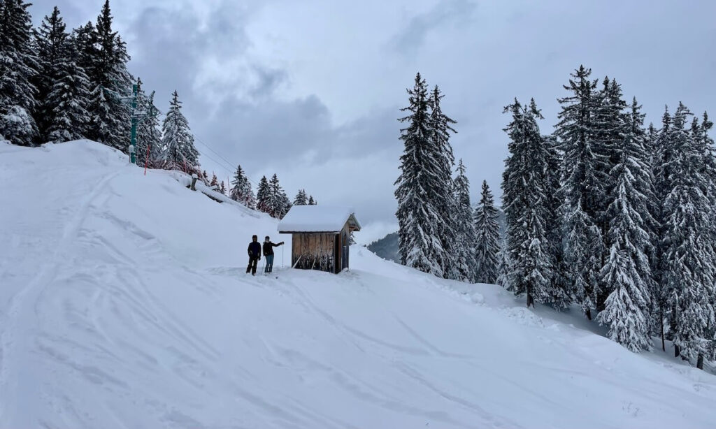 Standing at the top of ski run after fresh snow in Bernex France