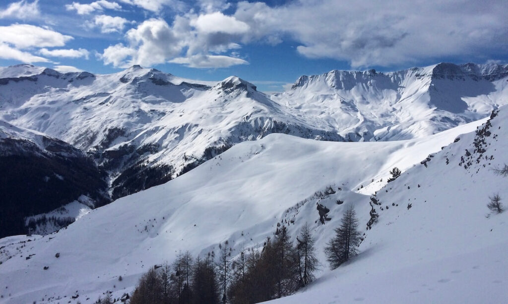 Snow-topped mountains and ski resort in Auron France on sunny day