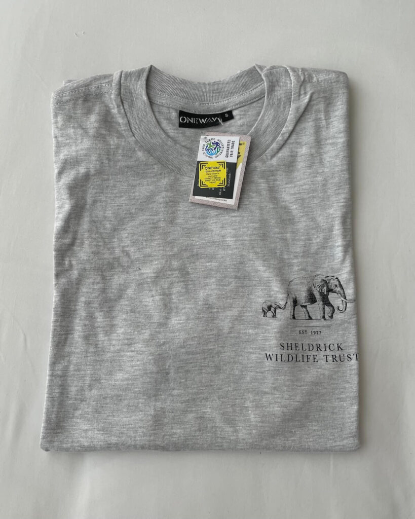 Sheldrick Elephant Orphanage t-shirt in grey folded onto white bed