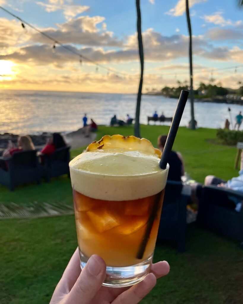 Mai Tai from Beach House restaurant with sunset backdrop of the ocean