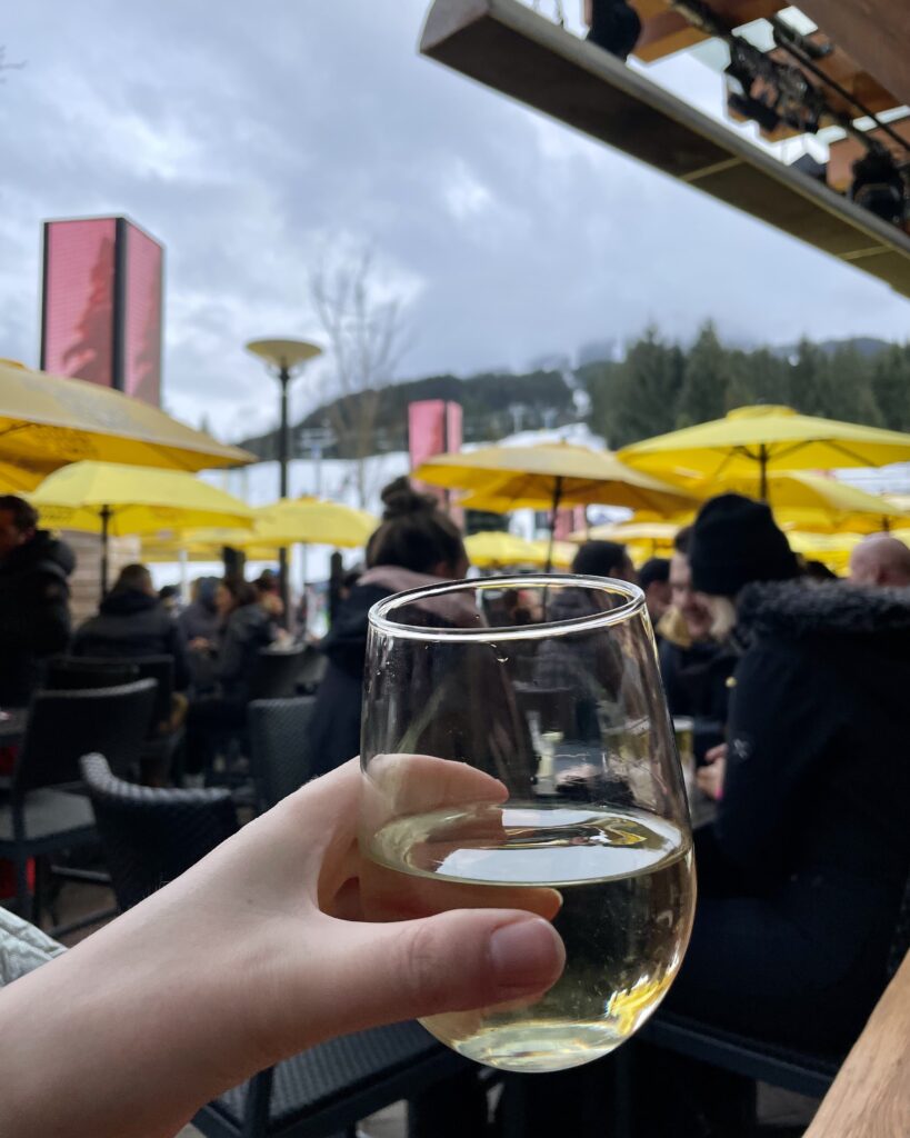 White wine held up at Apres Ski drinks at Longhorn's Whistler Blackcomb