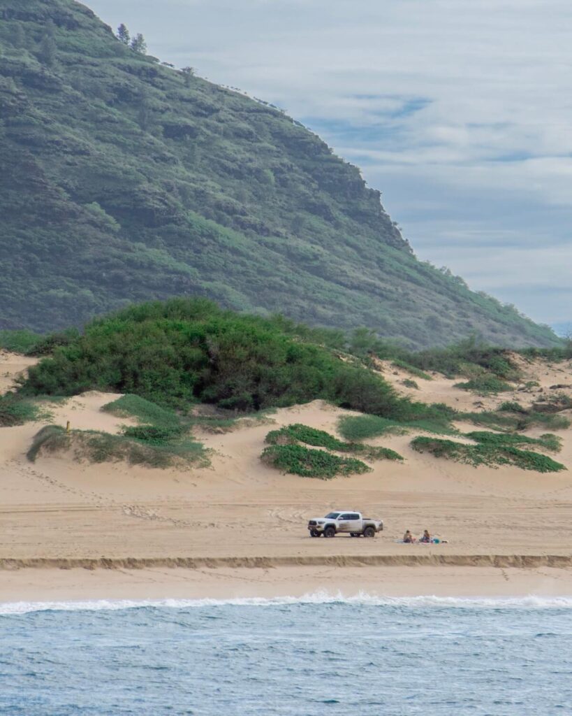 Polihale State Park beach Kauai - people sitting next to 4x4 truck on beach