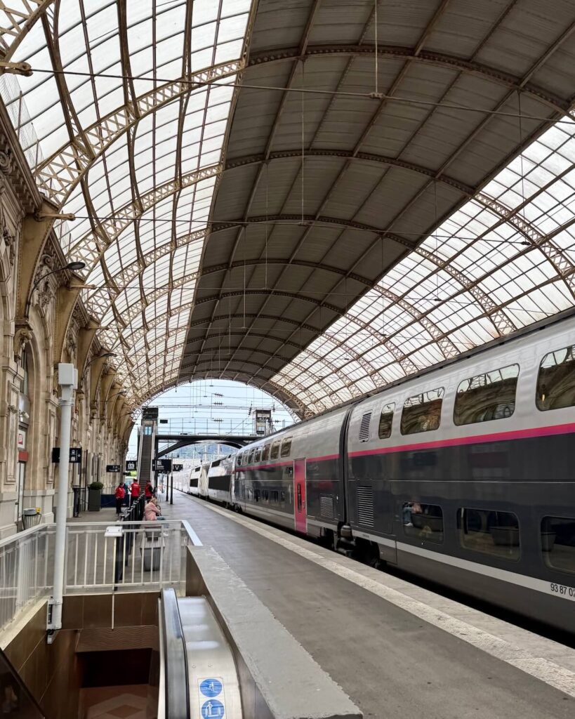 Nice ville train station with double decker train at platform and tall ceiling