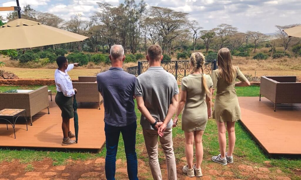 My family standing with their backs to the camera looking out across Giraffe Manor