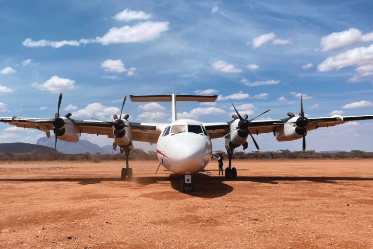 Packing list for safari in Kenya - propellor plane in Samburu sandy airstrip on sunny day
