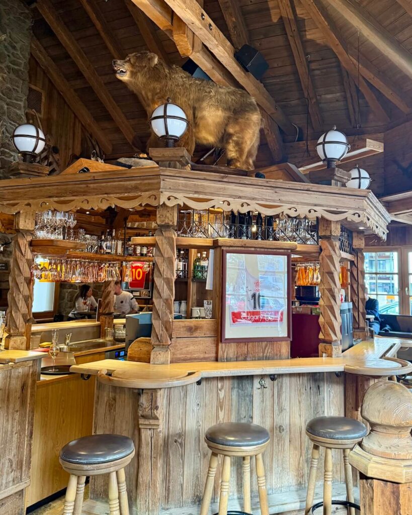 Grizzly Bar in Solden - circular bar with bar stools and life-size stuffed bear on top