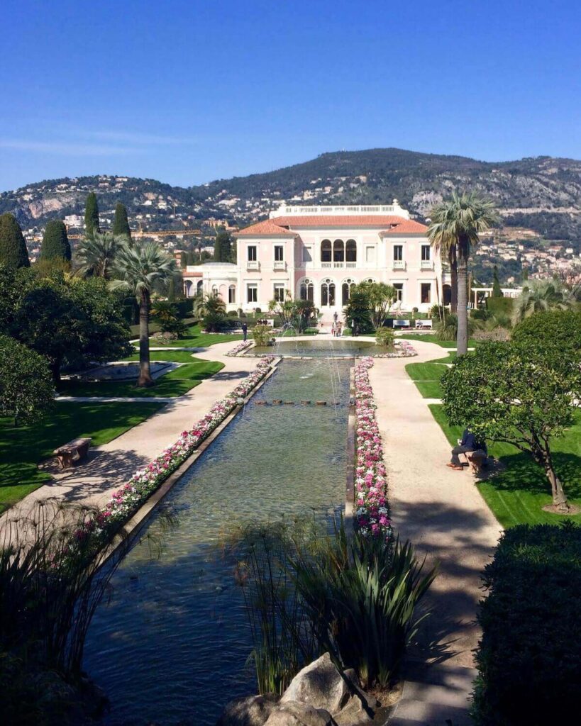 Villa Ephrussi de Rothschild in France - pink building with scenic gardens lining the building
