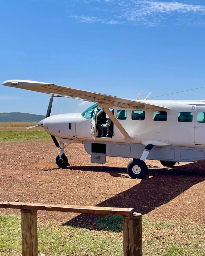 Small safari plane luggage compartment open on propellor plane on Masai Mara airstrip in Kenya