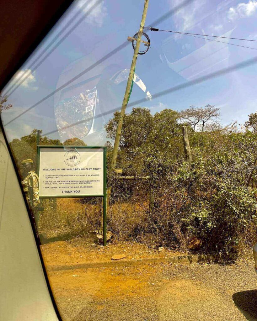 Sheldrick Wildlife Trust entrance with sign of rules and guard at gate in Nairobi National Park