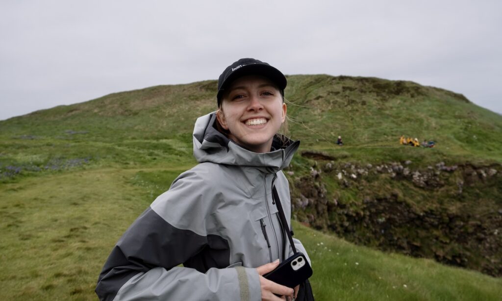 Grey berghaus raincoat - Samantha standing on top of hill on Staffa island waiting for Puffins