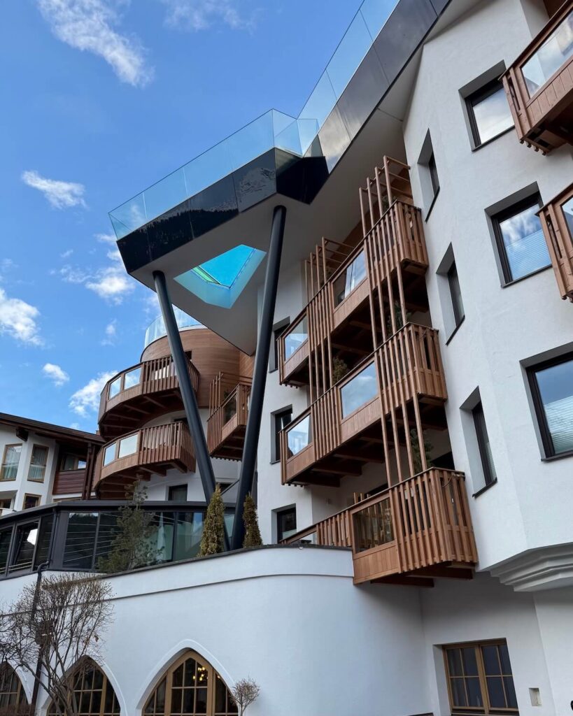 Das Central alpine hotel with view of pool from below with glass bottom and wooden balconies in Solden