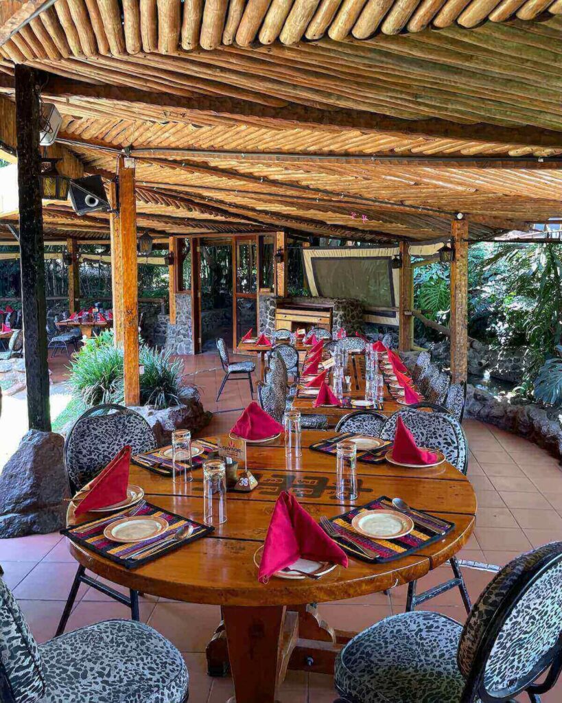 Carnivore Restaurant in Nairobi - table set up in courtyard with zebra print chairs and napkins on plates