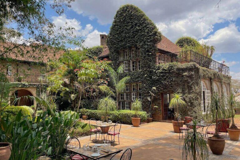 Can you visit Giraffe Manor without staying there - the main manor covered in vines with tables set for lunch on terrace