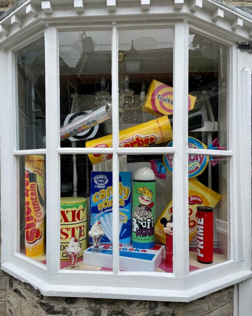 Sweet shop window display in Castleton Peak District - huge versions of British sweets such as Brain Licker, Fruit Salads and Sherbet Fountain